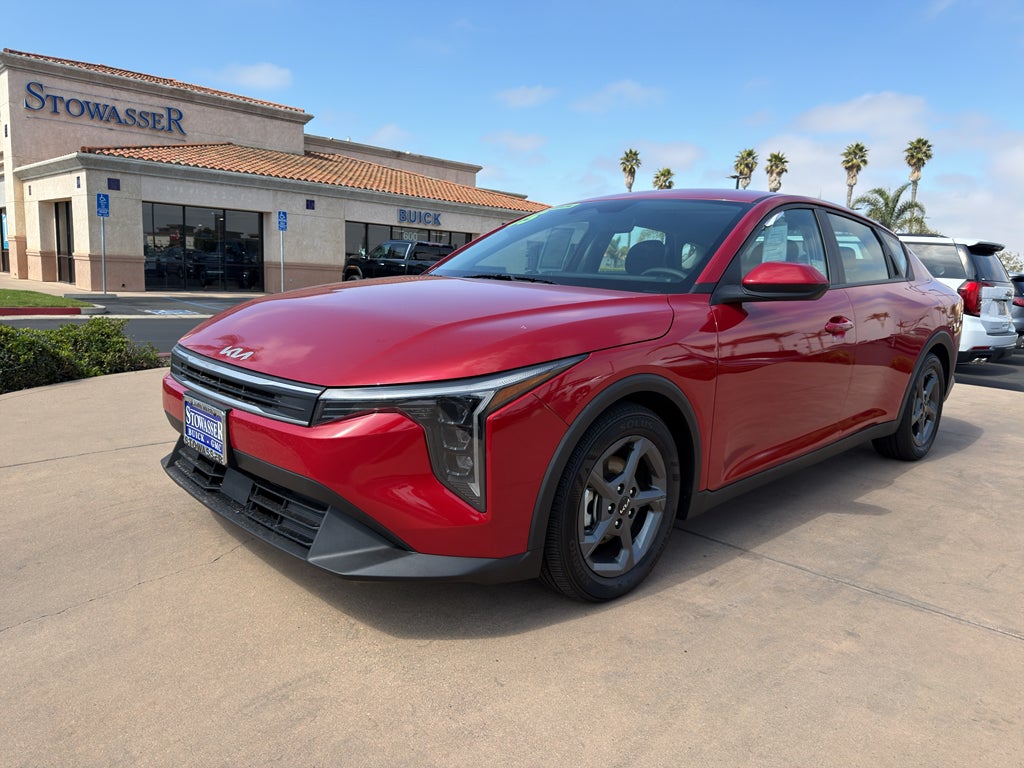 2025 Kia K4 LXS FWD in Red — front three-quarter view